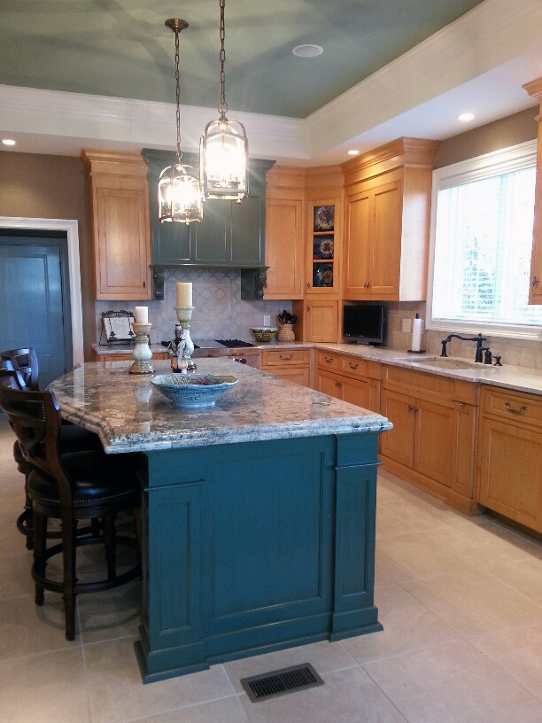 Open concept kitchen - mid-sized transitional u-shaped ceramic tile open concept kitchen idea with an undermount sink, recessed-panel cabinets, light wood cabinets, granite countertops, beige backsplash, ceramic backsplash, paneled appliances and an island