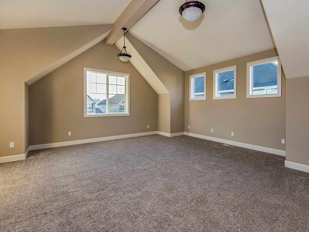 This is an example of a large transitional enclosed family room in Portland with beige walls, carpet, no fireplace and a wall-mounted tv.