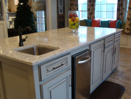 Transitional ceramic tile kitchen photo with an undermount sink, raised-panel cabinets, white cabinets, solid surface countertops, subway tile backsplash, stainless steel appliances and an island