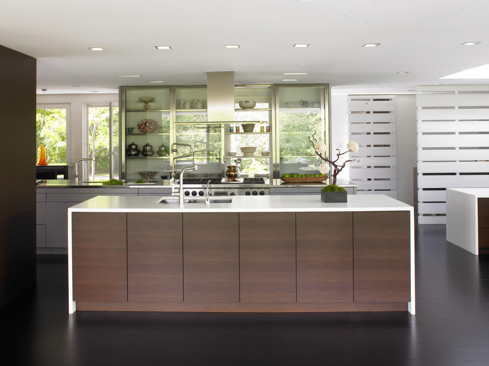 This is an example of a contemporary kitchen in Minneapolis with glass-front cabinets and stainless steel appliances.