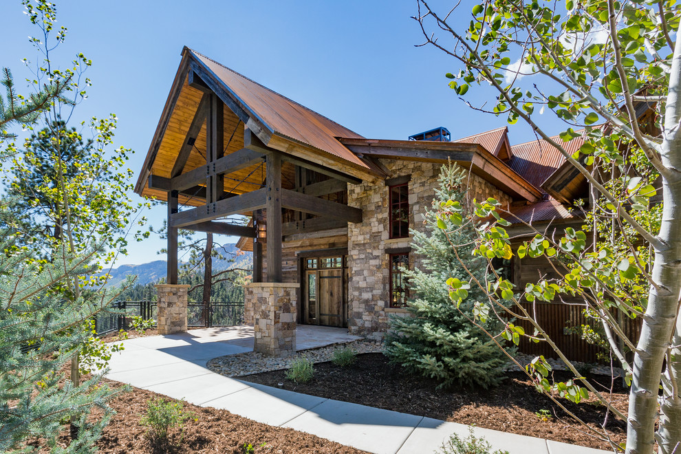 Large rustic multicolored two-story mixed siding house exterior idea with a shed roof and a metal roof