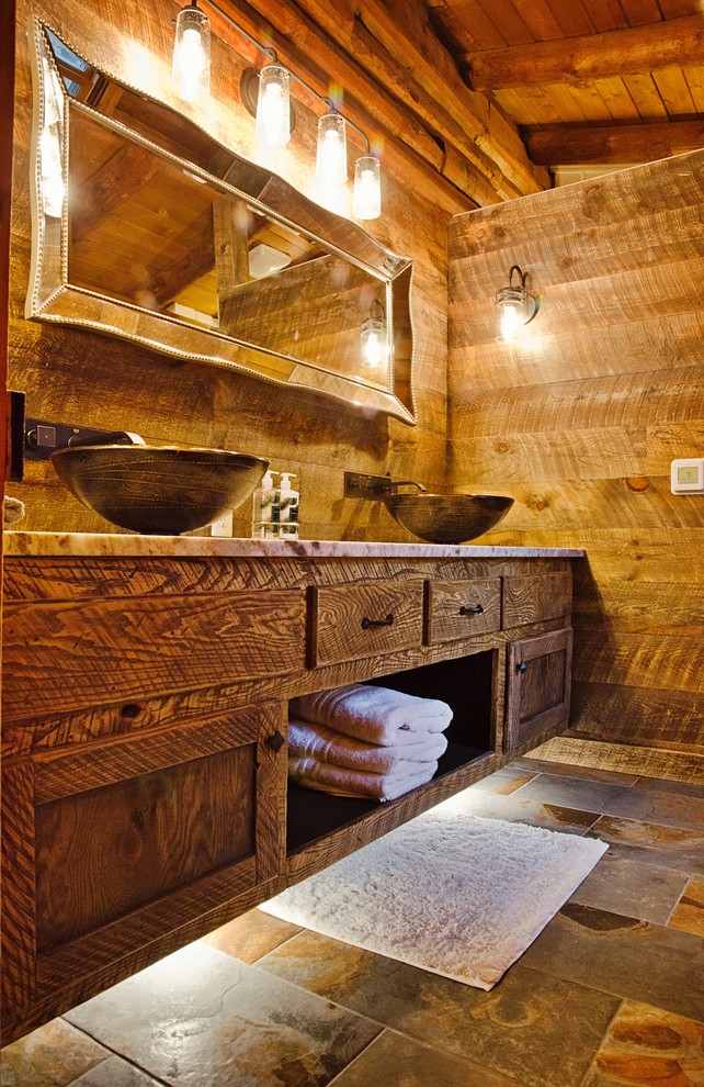 Example of a mid-sized mountain style 3/4 brown tile and ceramic tile ceramic tile and brown floor alcove shower design with recessed-panel cabinets, dark wood cabinets, a two-piece toilet, brown walls, a vessel sink and granite countertops