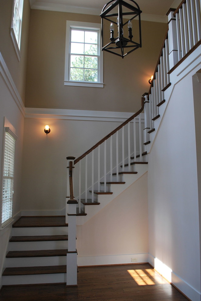 Example of a small transitional wooden u-shaped staircase design in Birmingham with painted risers