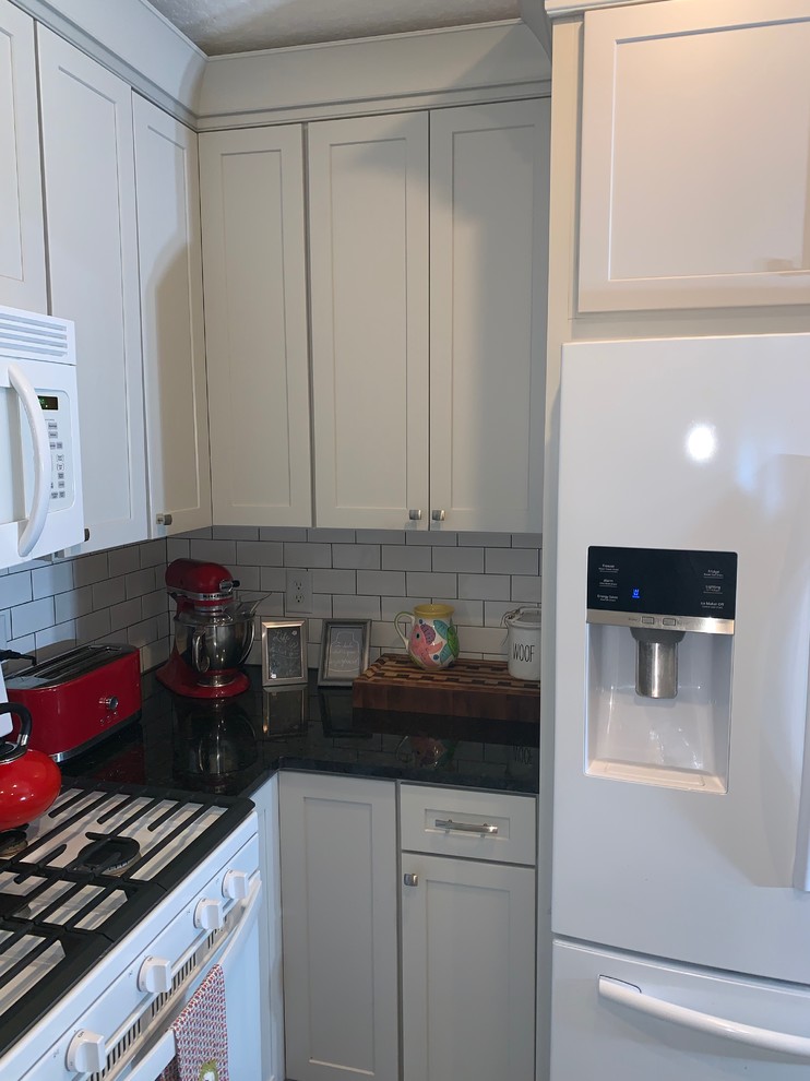 Small transitional u-shaped ceramic tile eat-in kitchen photo in Orlando with an undermount sink, shaker cabinets, gray cabinets, granite countertops, subway tile backsplash and no island