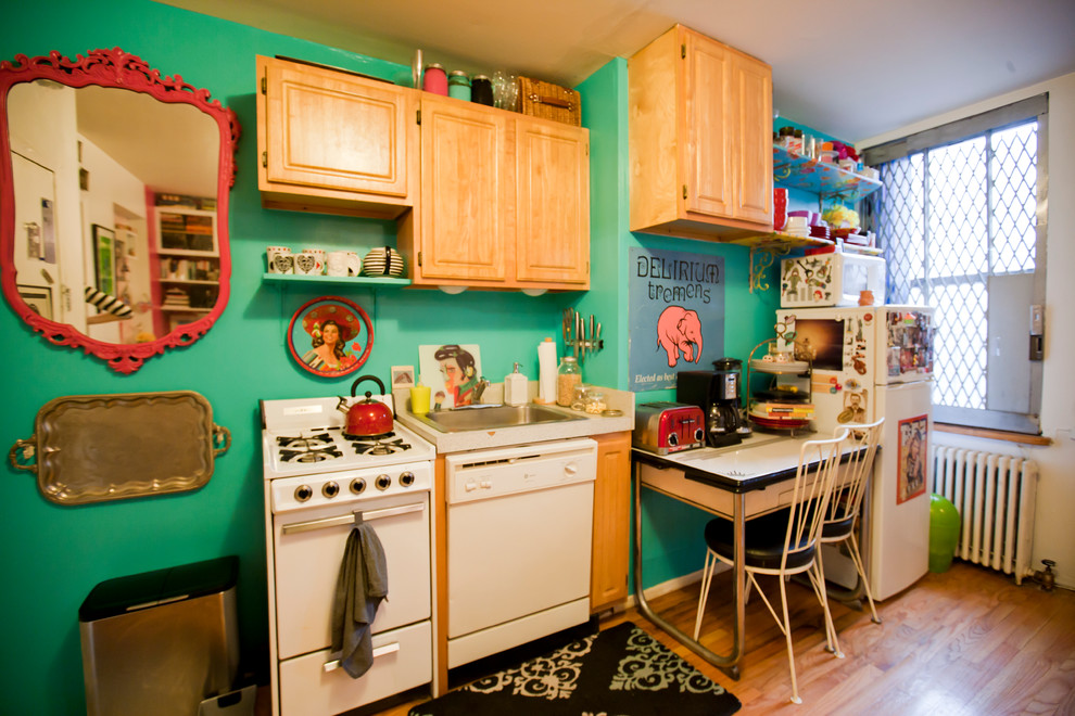 Small eclectic single-wall eat-in kitchen in New York with green splashback and medium hardwood floors.