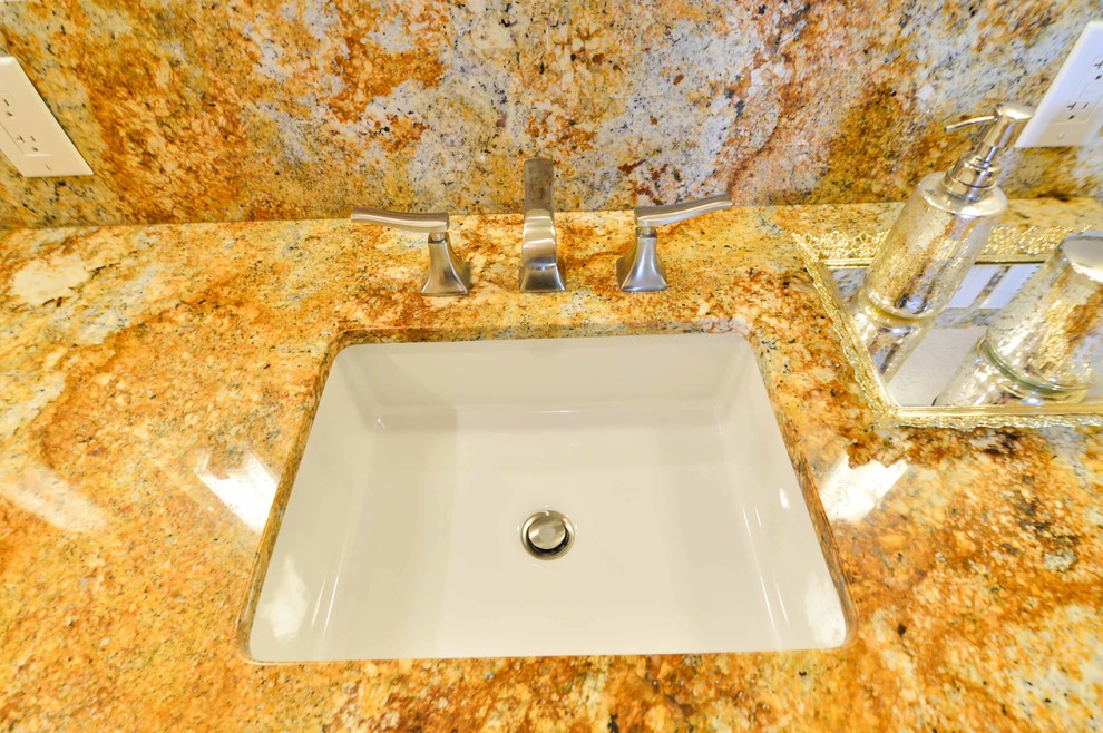 Inspiration for a mid-sized contemporary master bathroom in Tampa with an undermount sink, shaker cabinets, dark wood cabinets, granite benchtops, a curbless shower, a two-piece toilet, beige tile, porcelain tile, beige walls and porcelain floors.