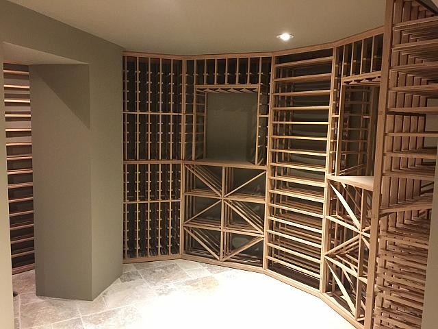 Photo of a mid-sized contemporary wine cellar in Toronto with ceramic floors, storage racks and beige floor.
