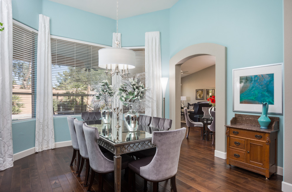 Mid-sized transitional dark wood floor enclosed dining room photo in Phoenix with blue walls and no fireplace