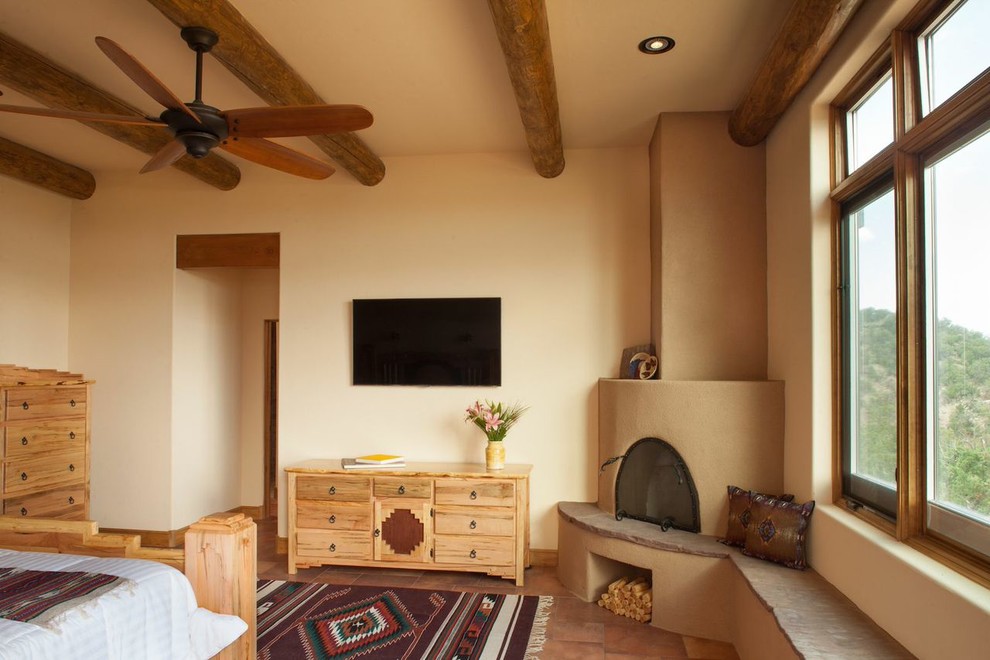 Design ideas for a bedroom in Albuquerque with beige walls, ceramic floors and a corner fireplace.