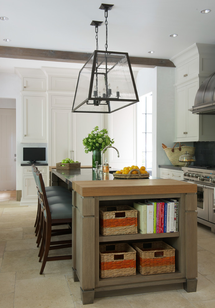 Example of a transitional kitchen design in Houston with shaker cabinets, white cabinets and an island
