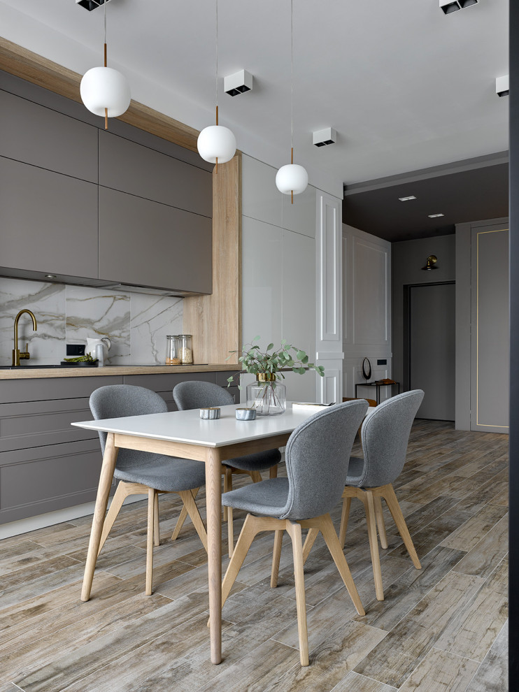 Inspiration for a contemporary grey and white single-wall open plan kitchen in Moscow with flat-panel cabinets, grey cabinets, grey splashback and beige floors.