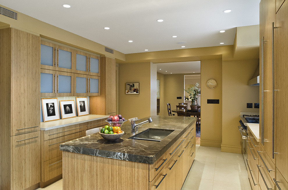 Contemporary galley separate kitchen in New York with an undermount sink, flat-panel cabinets and medium wood cabinets.