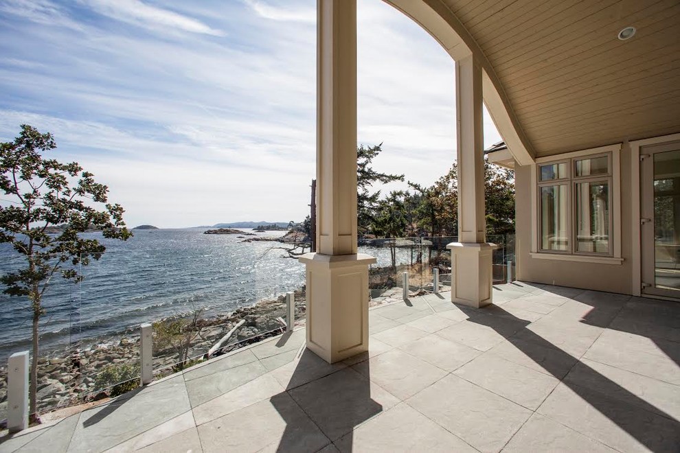 Patio - mid-sized transitional backyard concrete paver patio idea with a roof extension