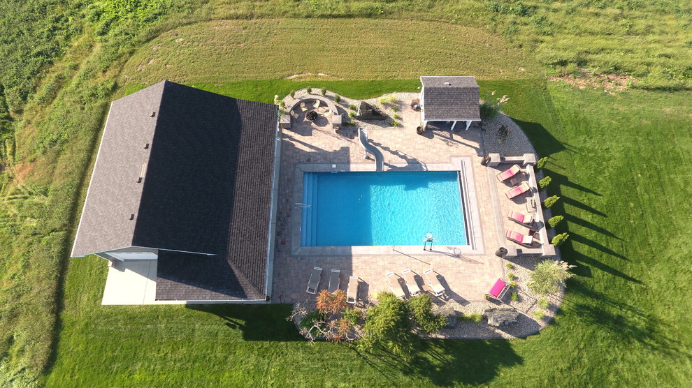 Inspiration for a mid-sized transitional backyard brick and rectangular lap pool house remodel