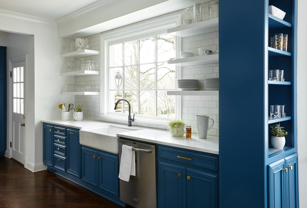 Inspiration for a transitional kitchen in Nashville with a farmhouse sink, open cabinets, blue cabinets, white splashback, subway tile splashback and stainless steel appliances.