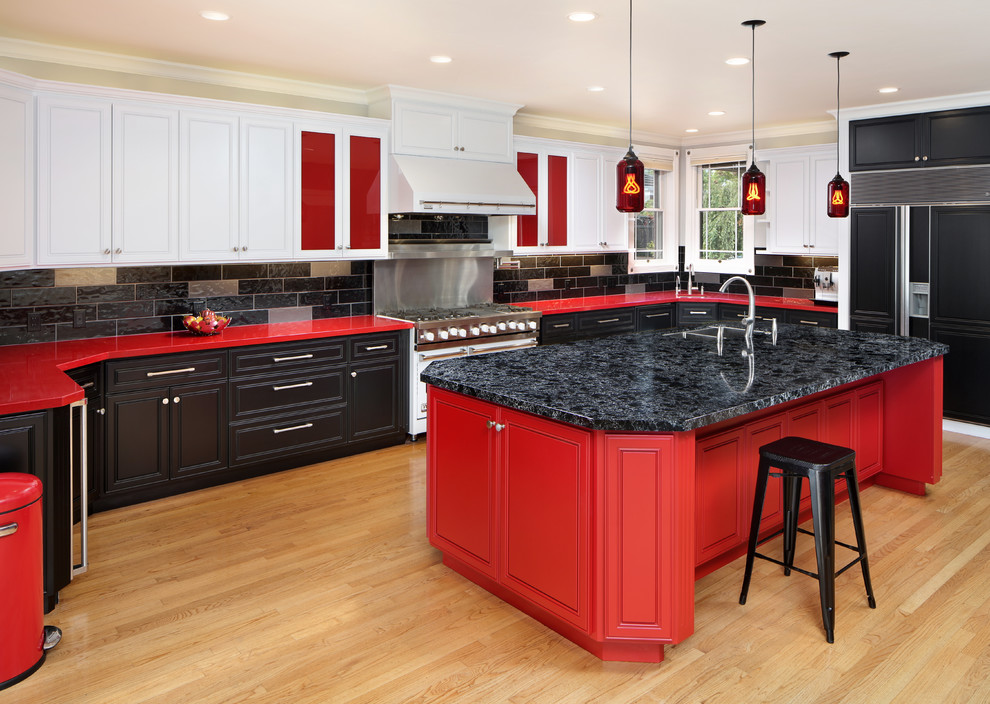 Transitional u-shaped kitchen in San Francisco with a double-bowl sink, beaded inset cabinets, red cabinets, black splashback, panelled appliances, light hardwood floors, with island, beige floor and red benchtop.