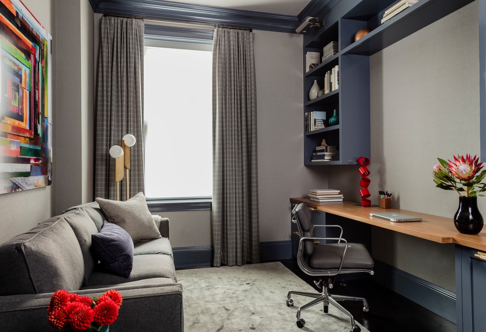 Design ideas for a mid-sized transitional study room in Boston with grey walls, carpet, a built-in desk and grey floor.