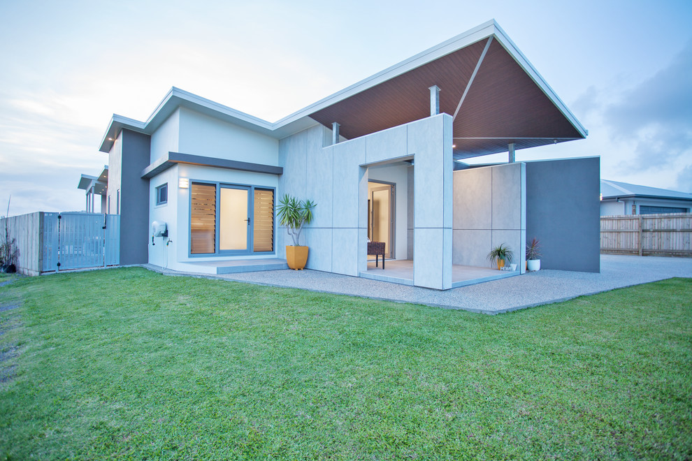 This is an example of a mid-sized contemporary one-storey grey house exterior in Other with mixed siding, a shed roof and a metal roof.