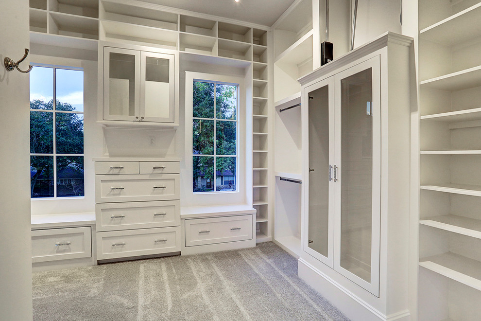 Design ideas for a large arts and crafts gender-neutral walk-in wardrobe in Houston with louvered cabinets, white cabinets, carpet and beige floor.