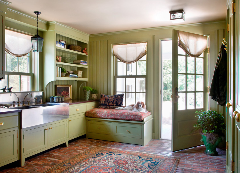Design ideas for a traditional mudroom in Boston with green walls and brick floors.