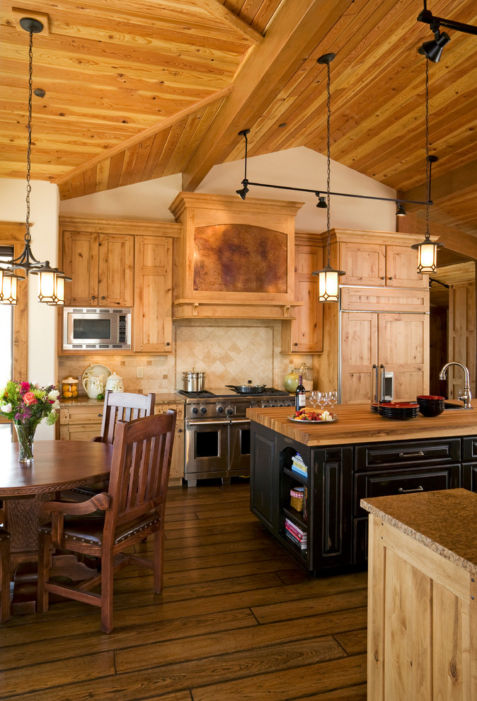 Design ideas for a country eat-in kitchen in Denver with recessed-panel cabinets, medium wood cabinets, wood benchtops and beige splashback.