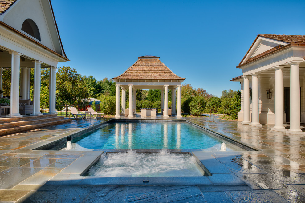 Example of a mid-sized transitional indoor stone and rectangular pool house design