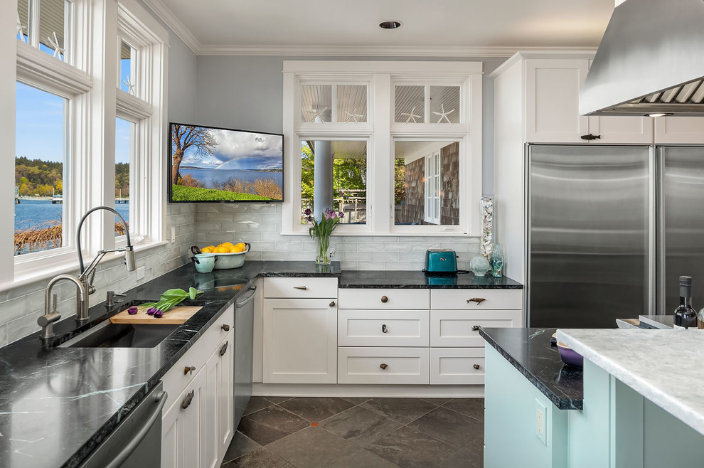 Inspiration for a large beach style open plan kitchen in Seattle with an undermount sink, shaker cabinets, soapstone benchtops, glass tile splashback, stainless steel appliances, slate floors, with island, green floor and green benchtop.