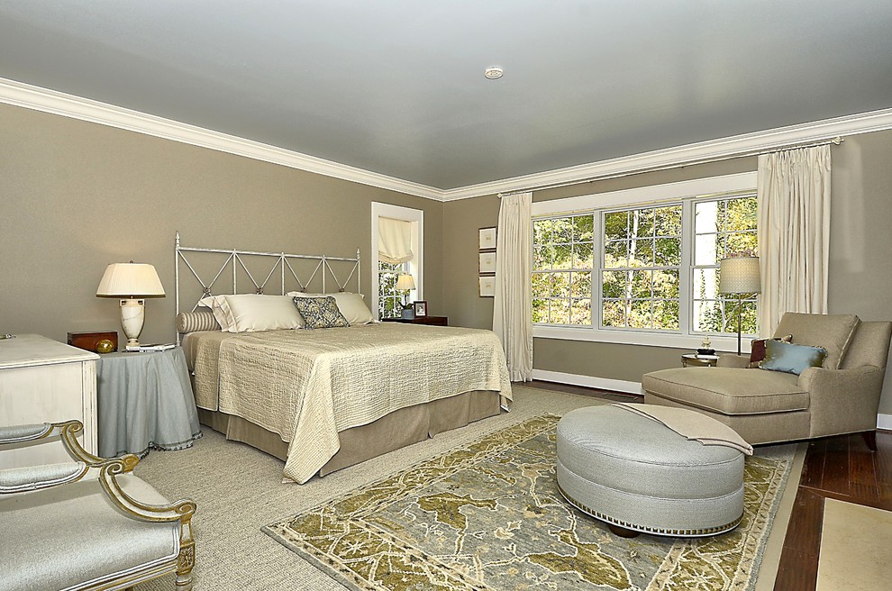 Inspiration for a large transitional master bedroom in Baltimore with beige walls, dark hardwood floors, a standard fireplace, a tile fireplace surround and brown floor.