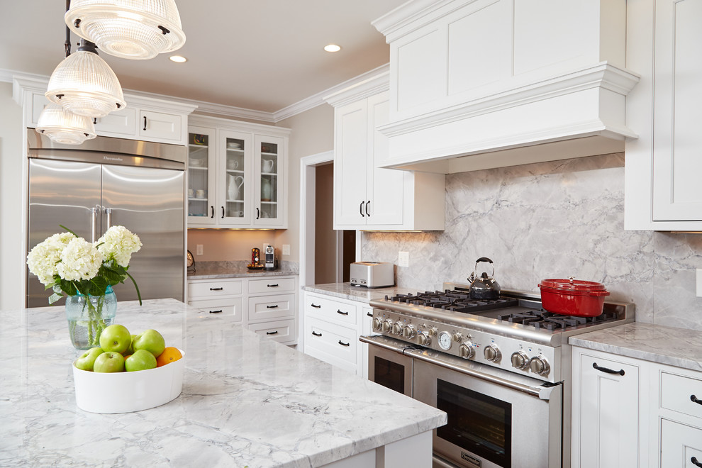 Design ideas for a beach style kitchen in Boston with a farmhouse sink, beaded inset cabinets, white cabinets, marble benchtops, white splashback, subway tile splashback, stainless steel appliances, medium hardwood floors and with island.