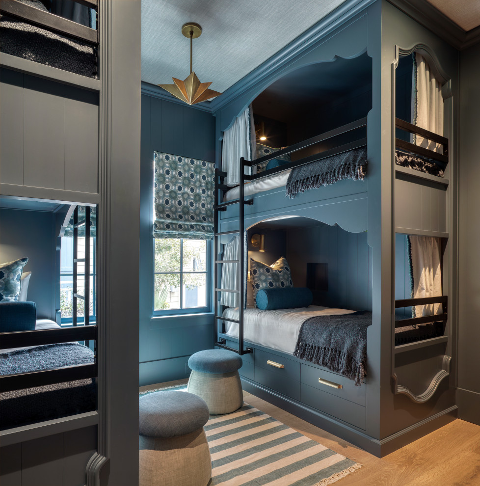 Beach style medium tone wood floor, wallpaper ceiling and wallpaper kids' room photo in Miami with blue walls