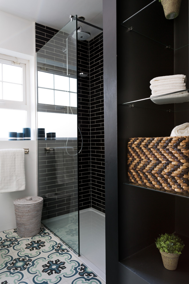 Inspiration for a small contemporary 3/4 bathroom in Limerick with recessed-panel cabinets, blue cabinets, an open shower, a one-piece toilet, black tile, subway tile, white walls, cement tiles, a drop-in sink, quartzite benchtops, multi-coloured floor, an open shower and white benchtops.