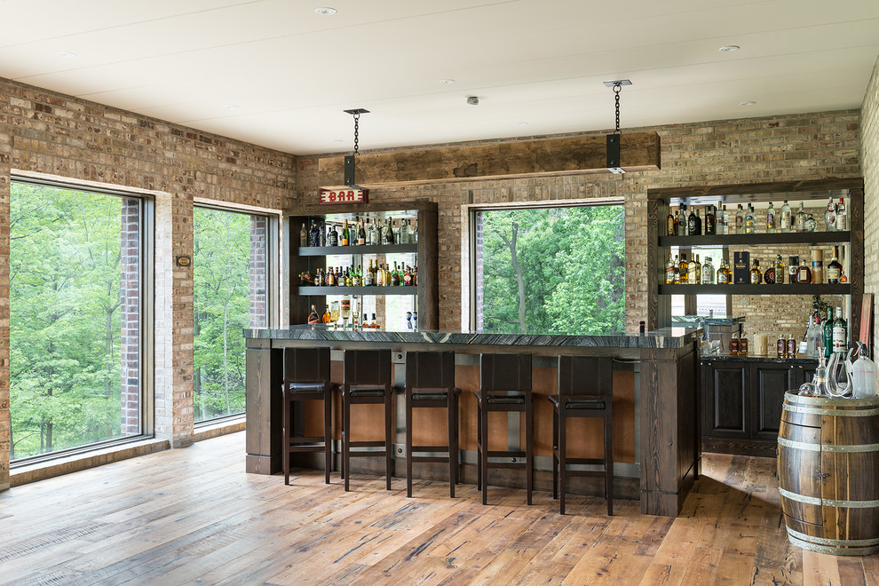 Design ideas for an expansive industrial galley seated home bar in Toronto with beaded inset cabinets, dark wood cabinets, brown splashback, brick splashback and beige floor.