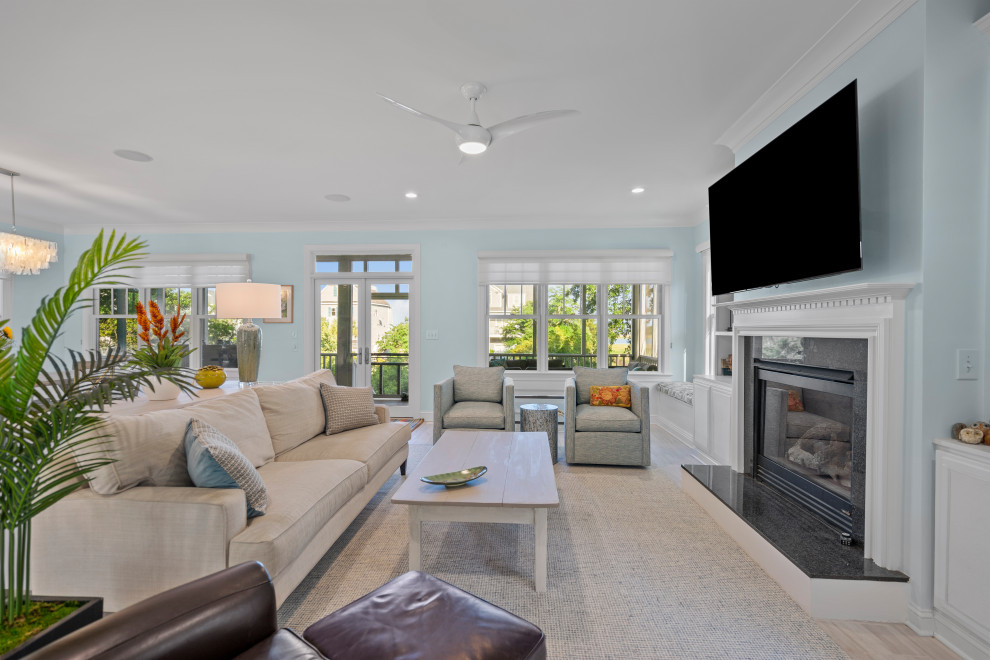 Large beach style living room in Wilmington with blue walls, ceramic floors, a standard fireplace, a stone fireplace surround and grey floor.