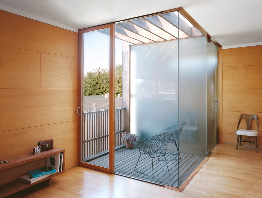 This is an example of a small contemporary balcony in Los Angeles with a roof extension.