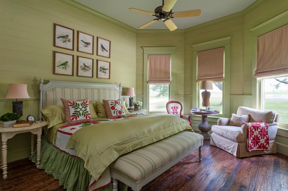 Photo of a country bedroom in Houston with green walls and dark hardwood floors.