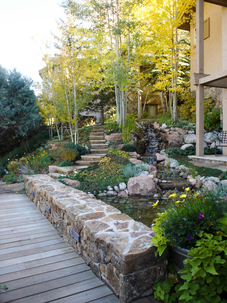 This is an example of a traditional garden in Denver with a water feature.