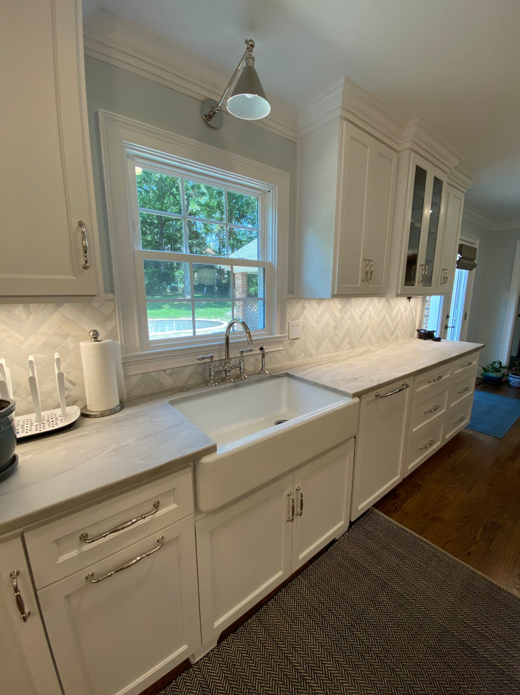 Mid-sized arts and crafts galley kitchen pantry in Charlotte with shaker cabinets, white cabinets, marble benchtops, with island and grey benchtop.
