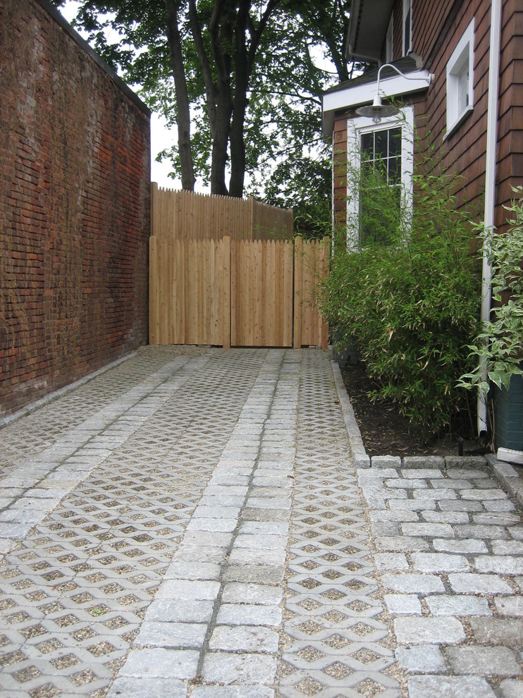 Traditional front yard partial sun driveway in Boston with gravel.