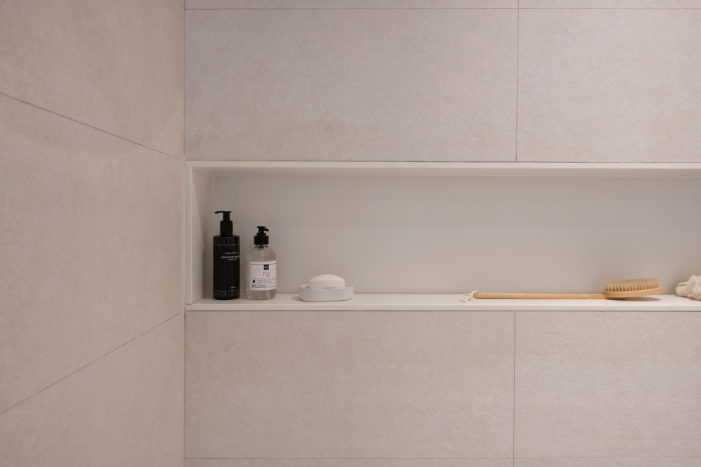Photo of a mid-sized scandinavian master bathroom in Other with flat-panel cabinets, light wood cabinets, an alcove shower, a wall-mount toilet, beige tile, porcelain tile, beige walls, porcelain floors, an undermount sink, engineered quartz benchtops, grey floor, a sliding shower screen, white benchtops, a laundry, a single vanity and a floating vanity.