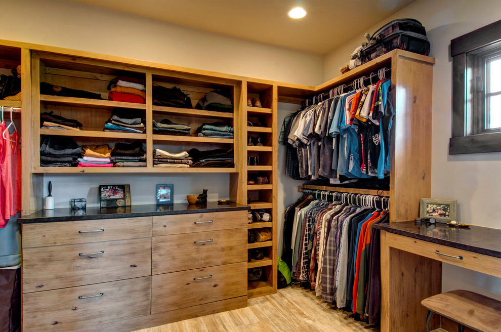 Example of a mountain style men's light wood floor closet design in Denver with flat-panel cabinets and light wood cabinets