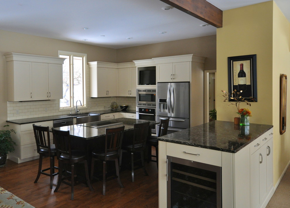 Transitional l-shaped eat-in kitchen photo in Grand Rapids with a farmhouse sink, shaker cabinets, quartz countertops, ceramic backsplash and stainless steel appliances