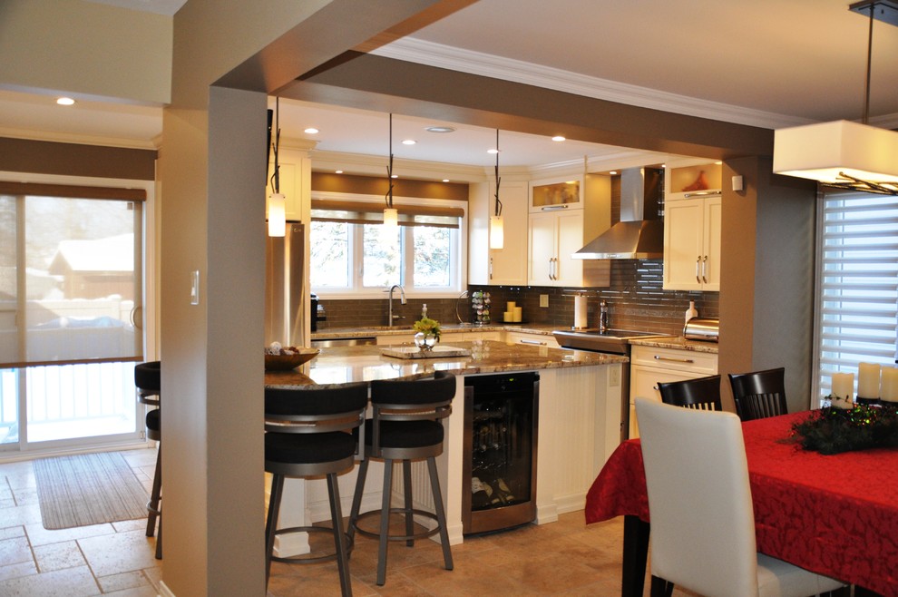 Example of a large transitional l-shaped ceramic tile open concept kitchen design in Ottawa with an undermount sink, shaker cabinets, beige cabinets, granite countertops, glass tile backsplash, stainless steel appliances and an island