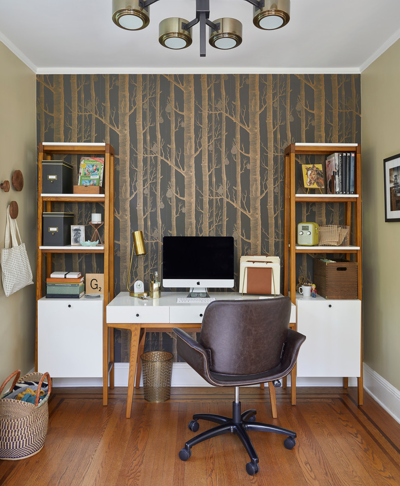 Inspiration for a mid-sized transitional home office in New York with no fireplace, a freestanding desk, green walls, medium hardwood floors and brown floor.