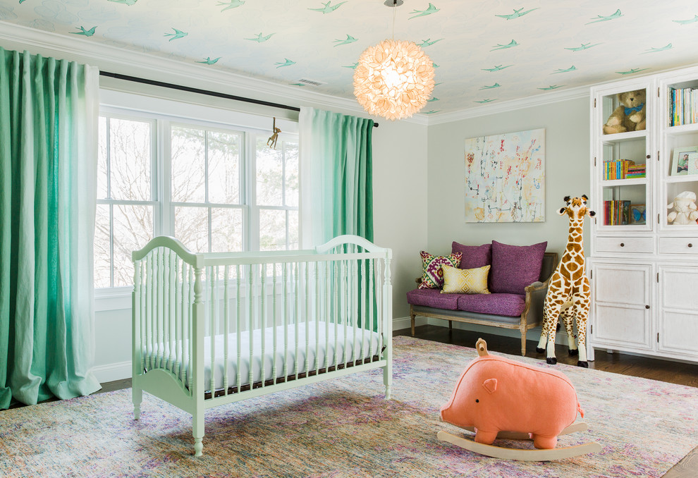 Transitional gender-neutral nursery in Boston with grey walls and dark hardwood floors.