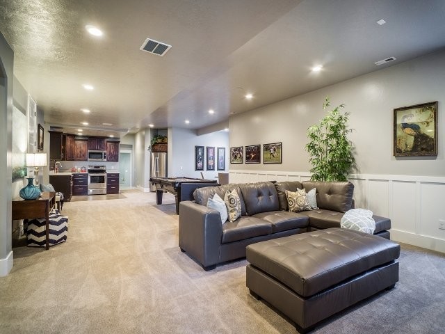 Design ideas for a mid-sized transitional look-out basement in Salt Lake City with grey walls, carpet and no fireplace.