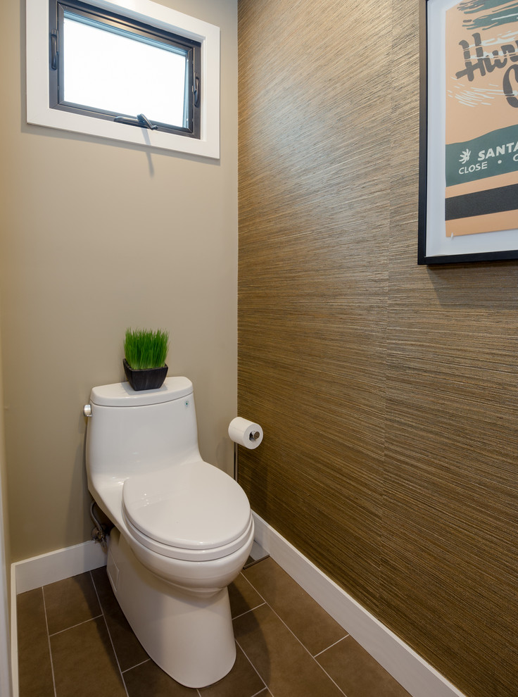 Photo of a small transitional powder room in Los Angeles with flat-panel cabinets, light wood cabinets, a one-piece toilet, multi-coloured walls, an undermount sink and engineered quartz benchtops.