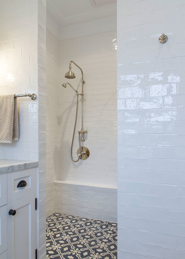 Large country master bathroom in Sydney with recessed-panel cabinets, white cabinets, an open shower, white tile, ceramic tile, white walls, cement tiles, a drop-in sink and marble benchtops.