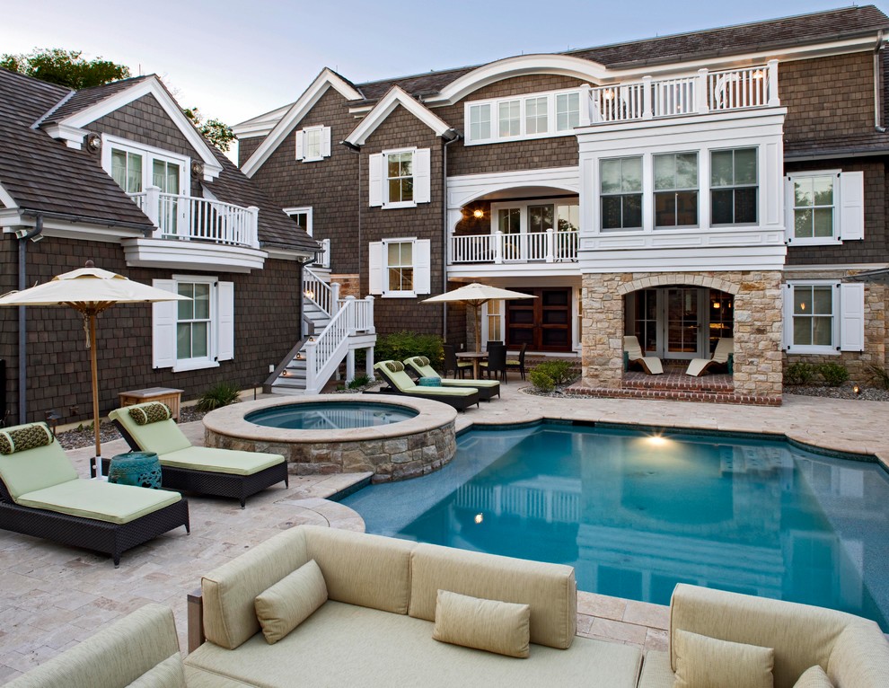This is an example of a traditional courtyard custom-shaped pool in DC Metro with natural stone pavers.