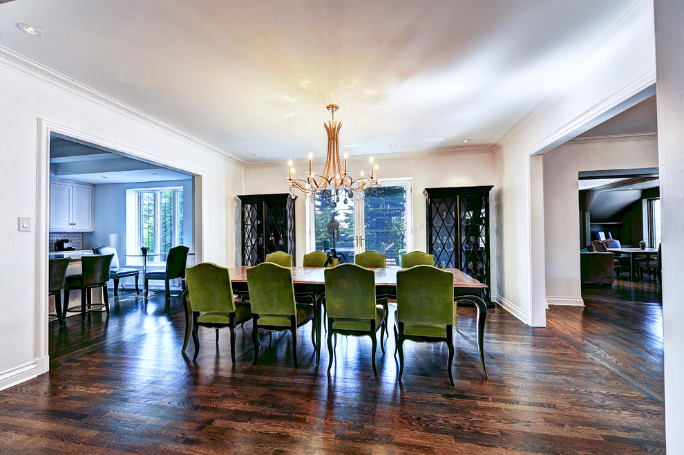 Large traditional open plan dining in Montreal with white walls, dark hardwood floors and no fireplace.