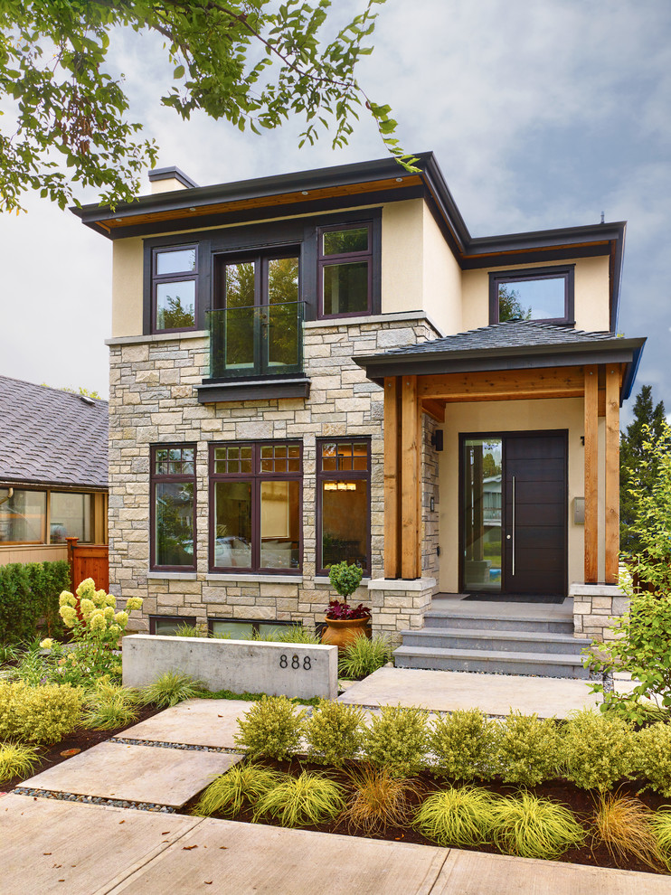 Inspiration for a small transitional two-storey house exterior in Vancouver with mixed siding.
